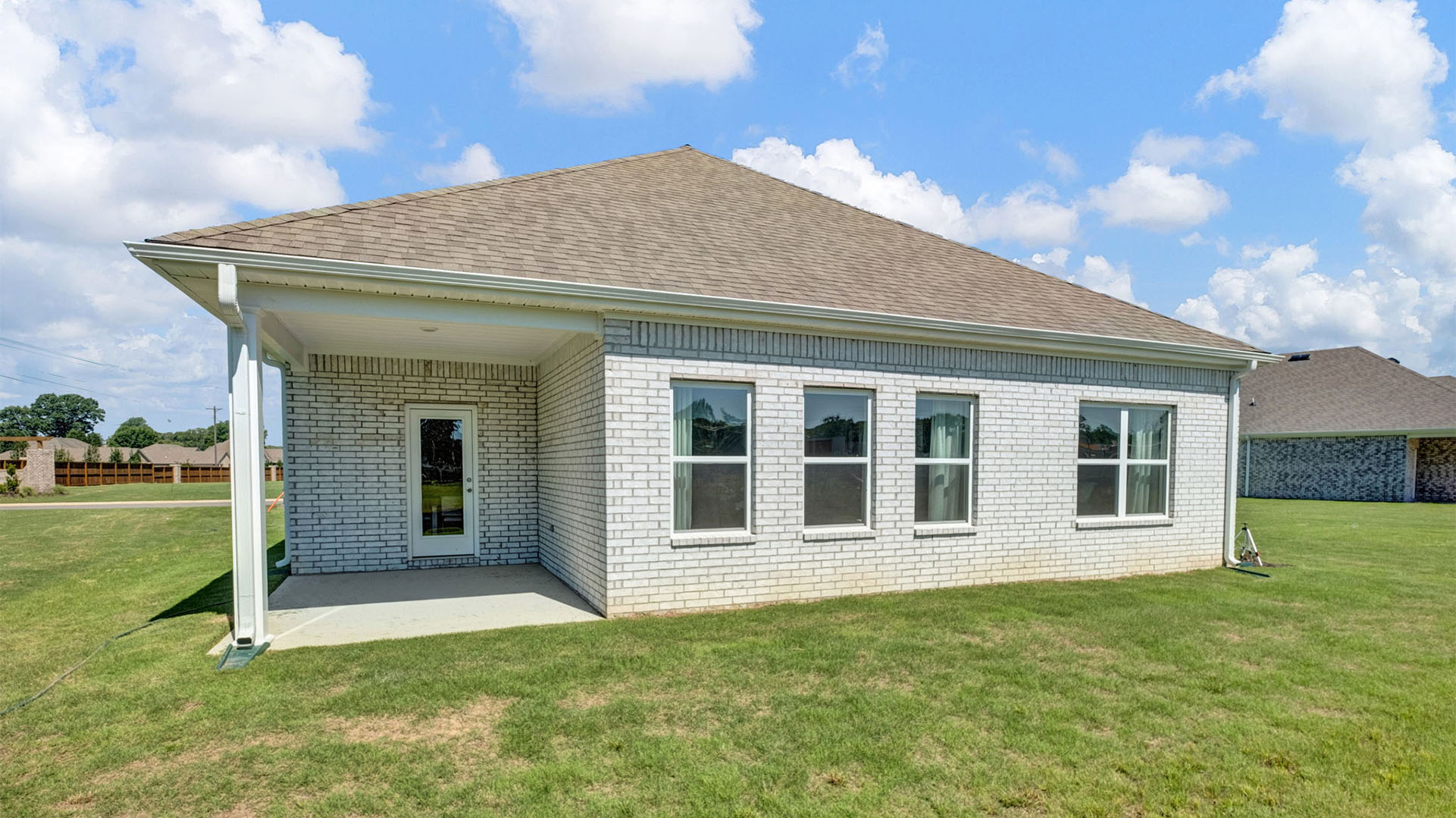 Back covered patio overlooking large backyard