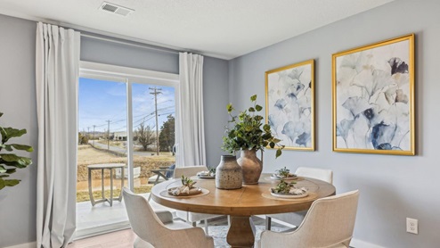 Dining area with door access out to covered patio