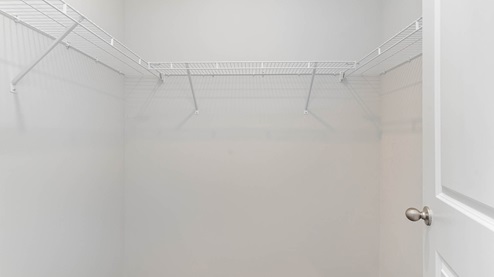 Primary closet with ventilated shelving