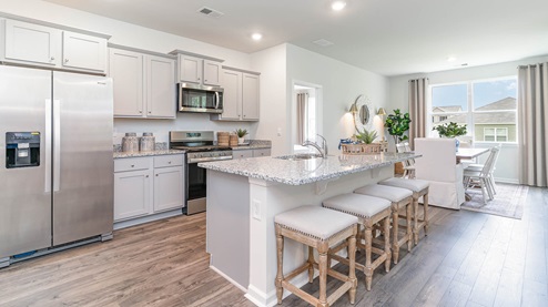 Beautiful kitchen with light cabinets and stainless steel appliances