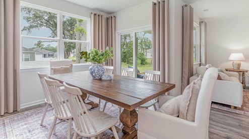 Dining area with a backwall double window overlooking the backyard