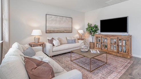 Spacious living room with neutral walls and vinyl flooring