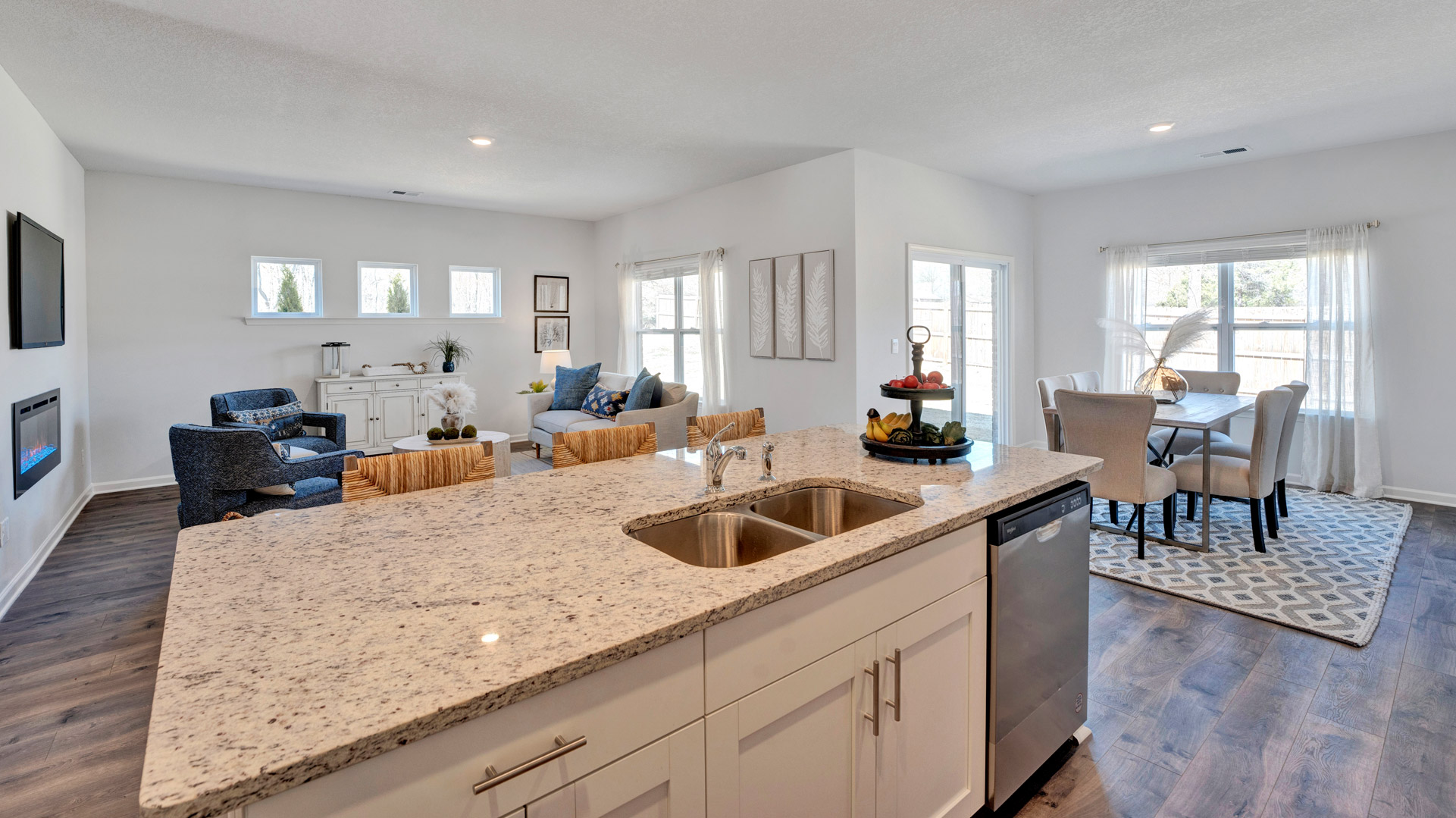 Contemporary kitchen with integrated island workspace, New appliances, and Fresh Open Concept flow into the living area.