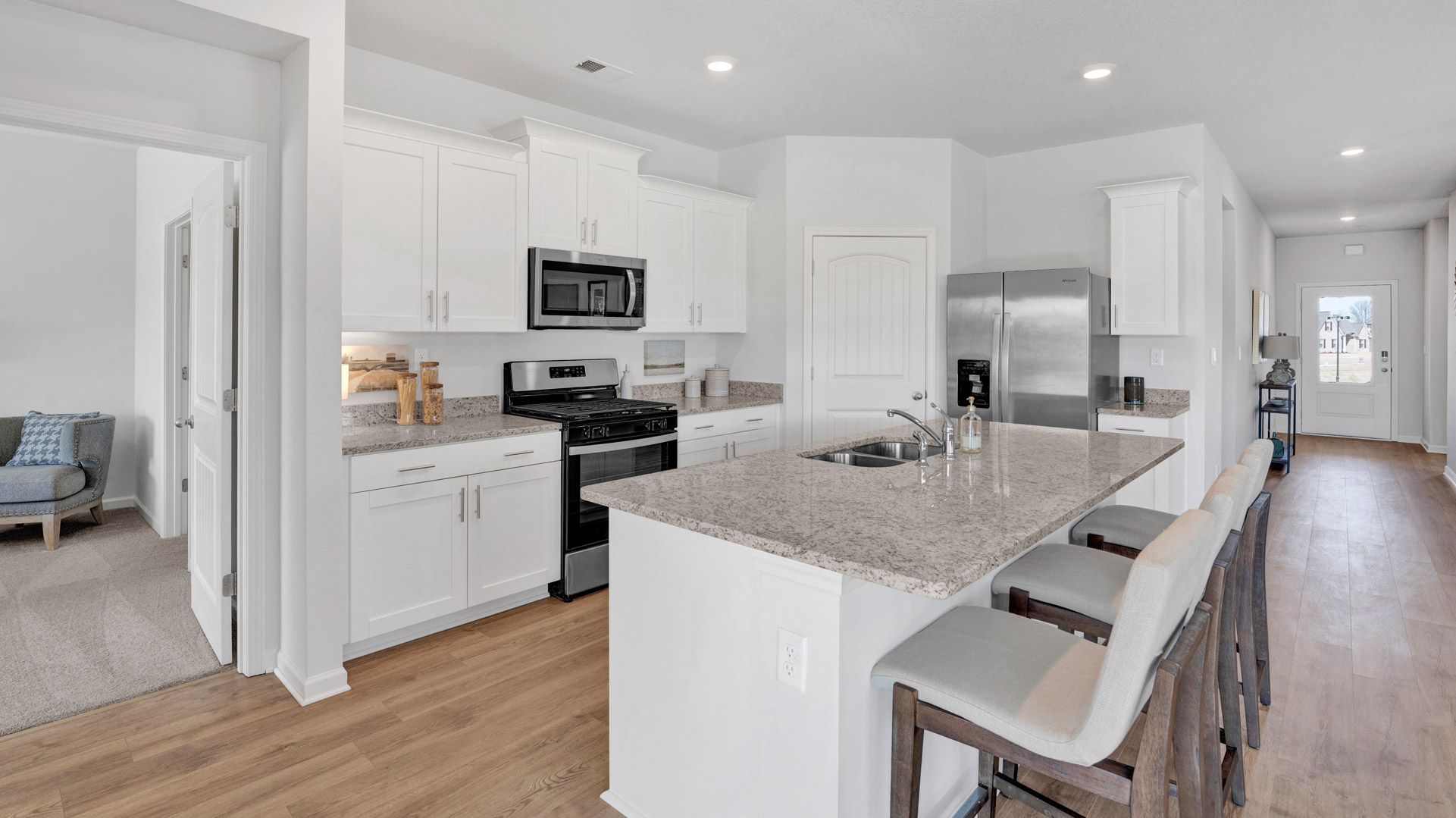 Beautiful kitchen opens up at the end of entry hall