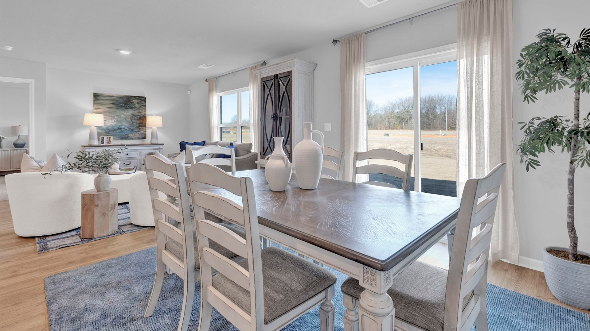 Open concept view of the dining room overlooking the living room