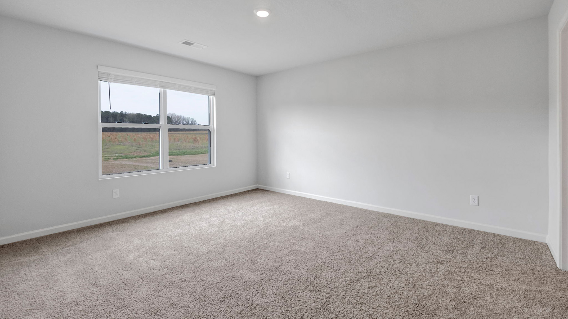 Primary bedroom with a double window for natural light