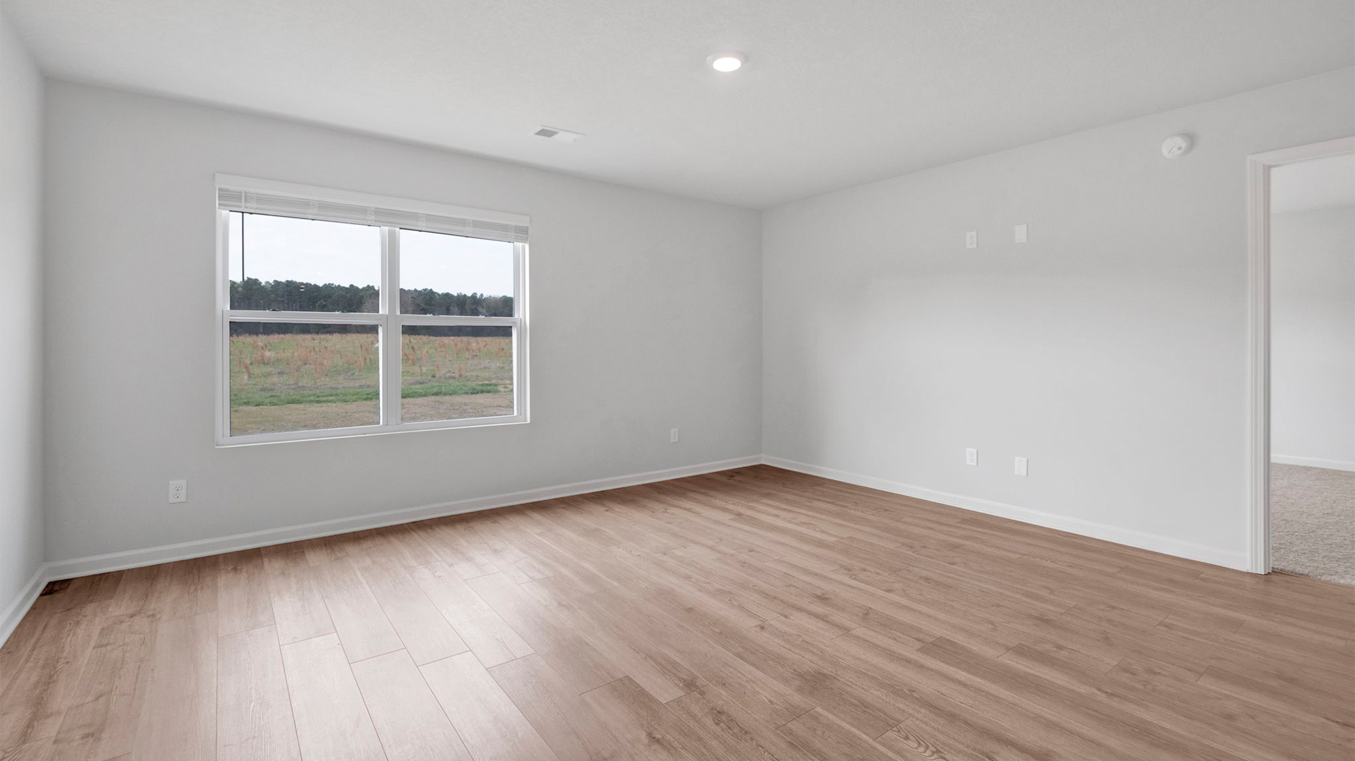 Living room with a double window overlooking the backyard
