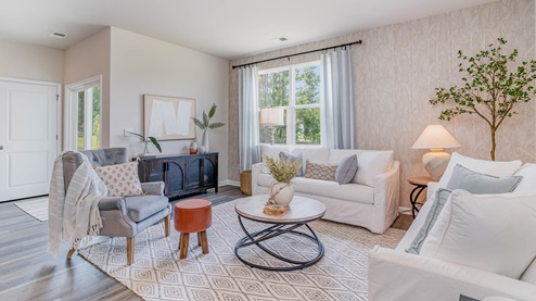 Living room with large double window overlooking the backyard