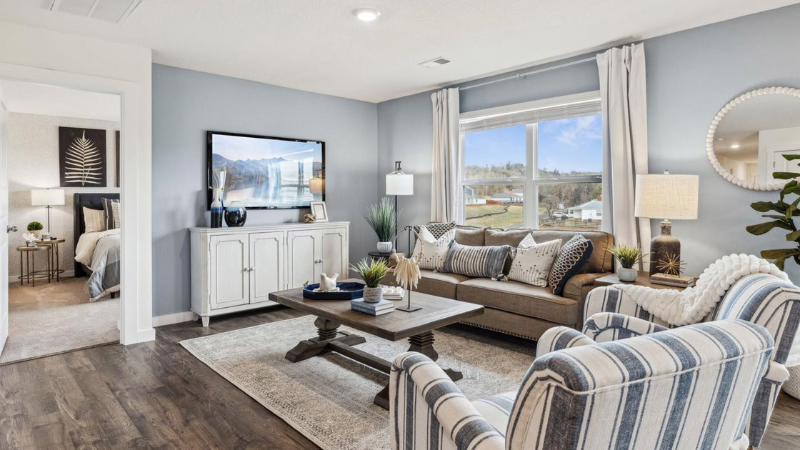 Living room with a large double window overlooking the backyard