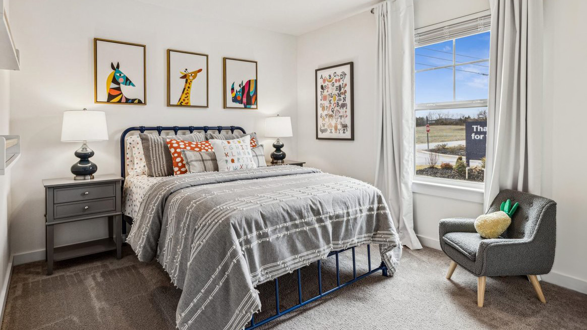 Second bedroom with carpet flooring and neutral walls
