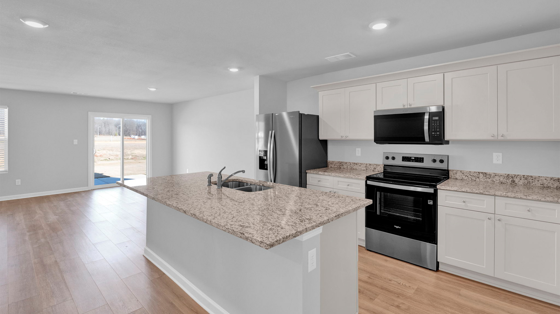Kitchen opens up at the end of long entry hall