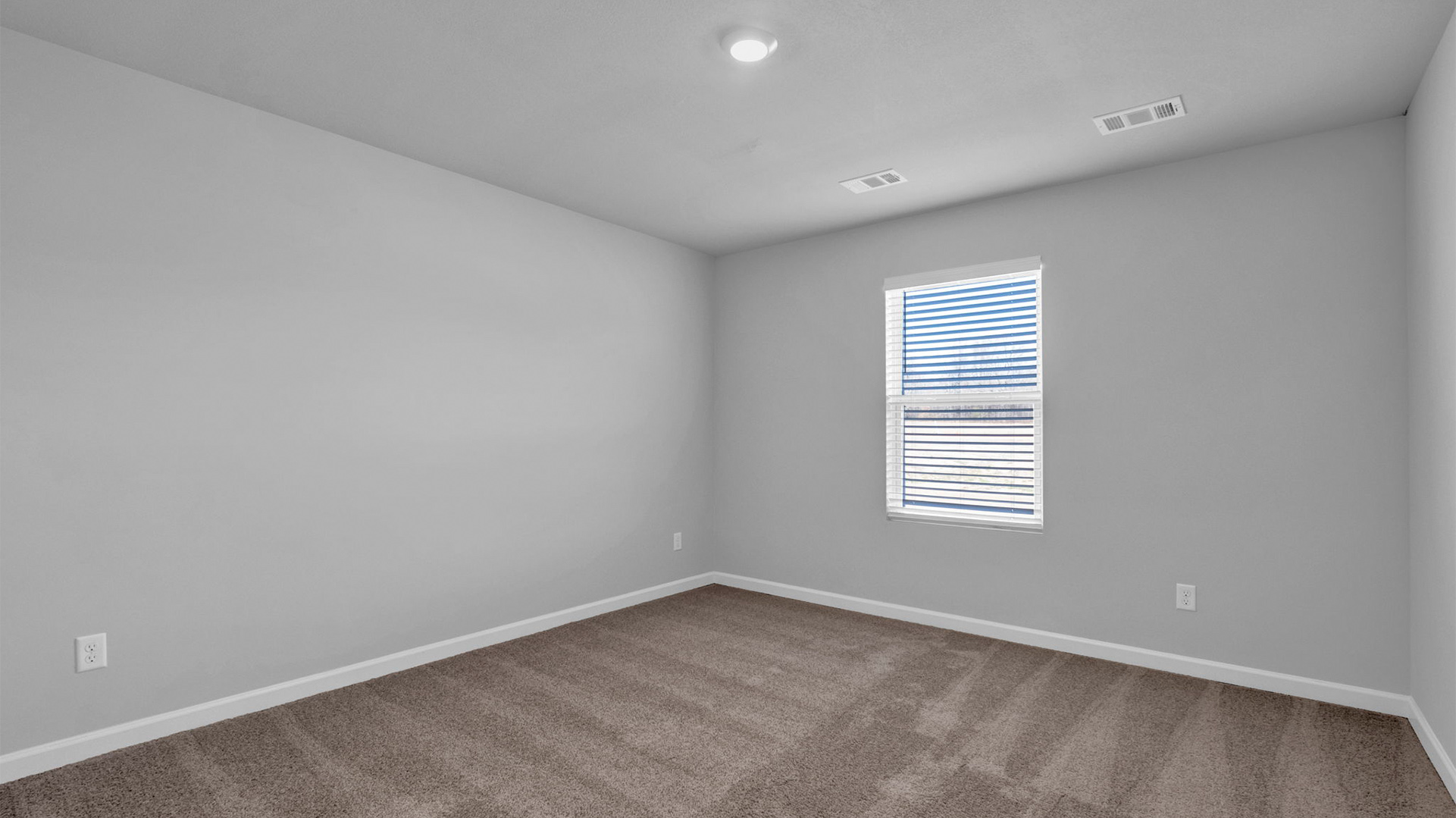 Primary bedroom at the rear of the home