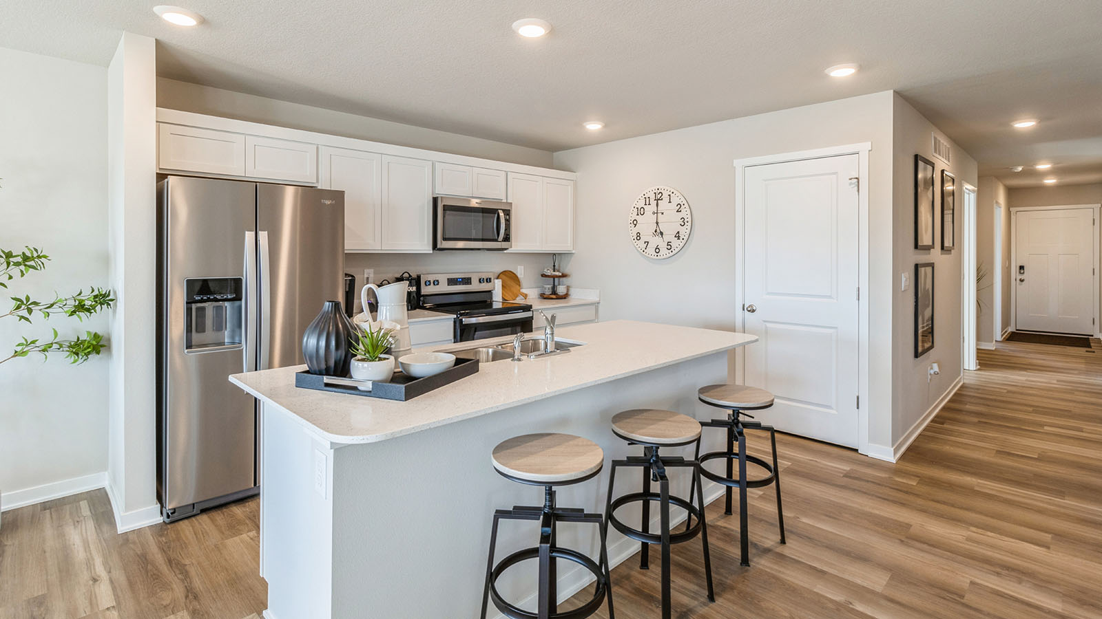 Kitchen opens up at the end of long entry hall