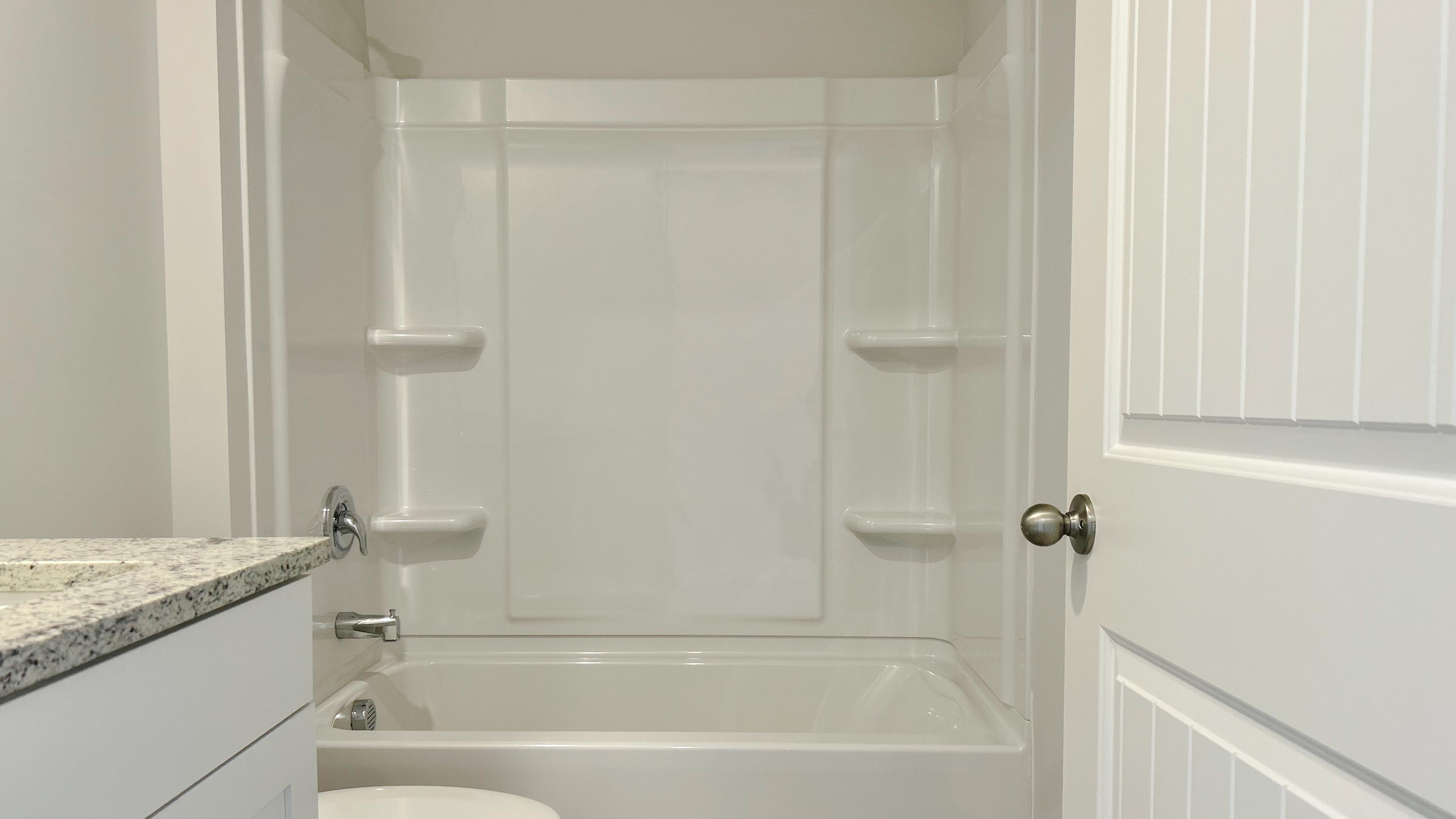 Second bathroom with a single vanity and an acrylic tub/shower insert