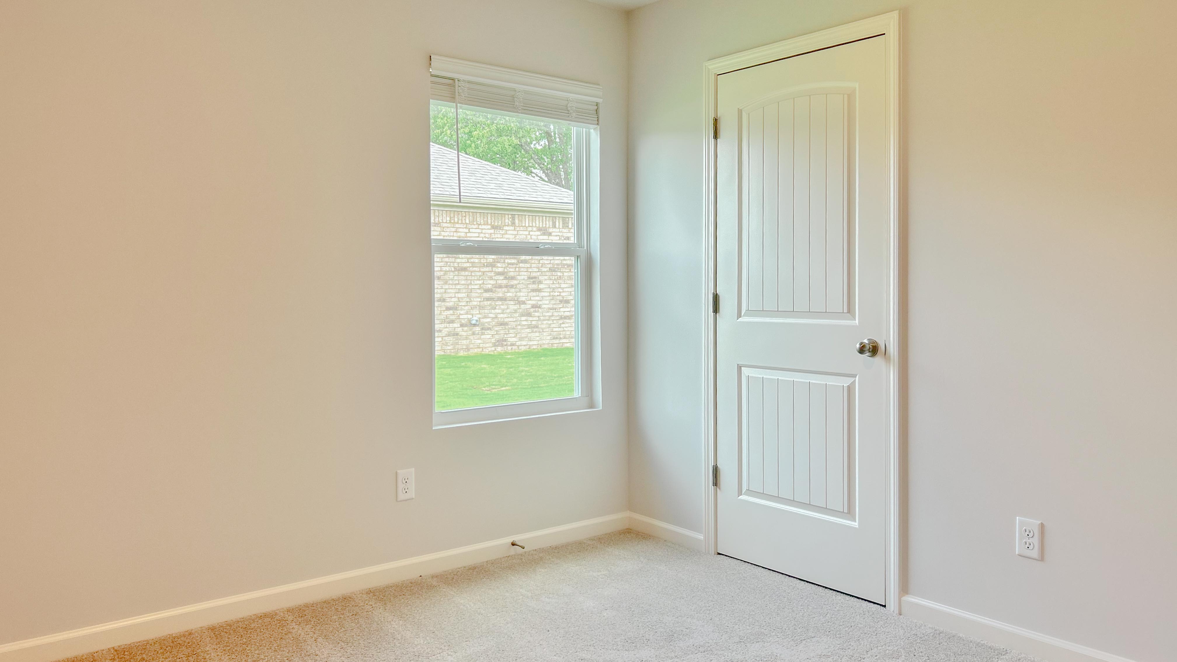Third bedroom with a single window overlooking the side yard