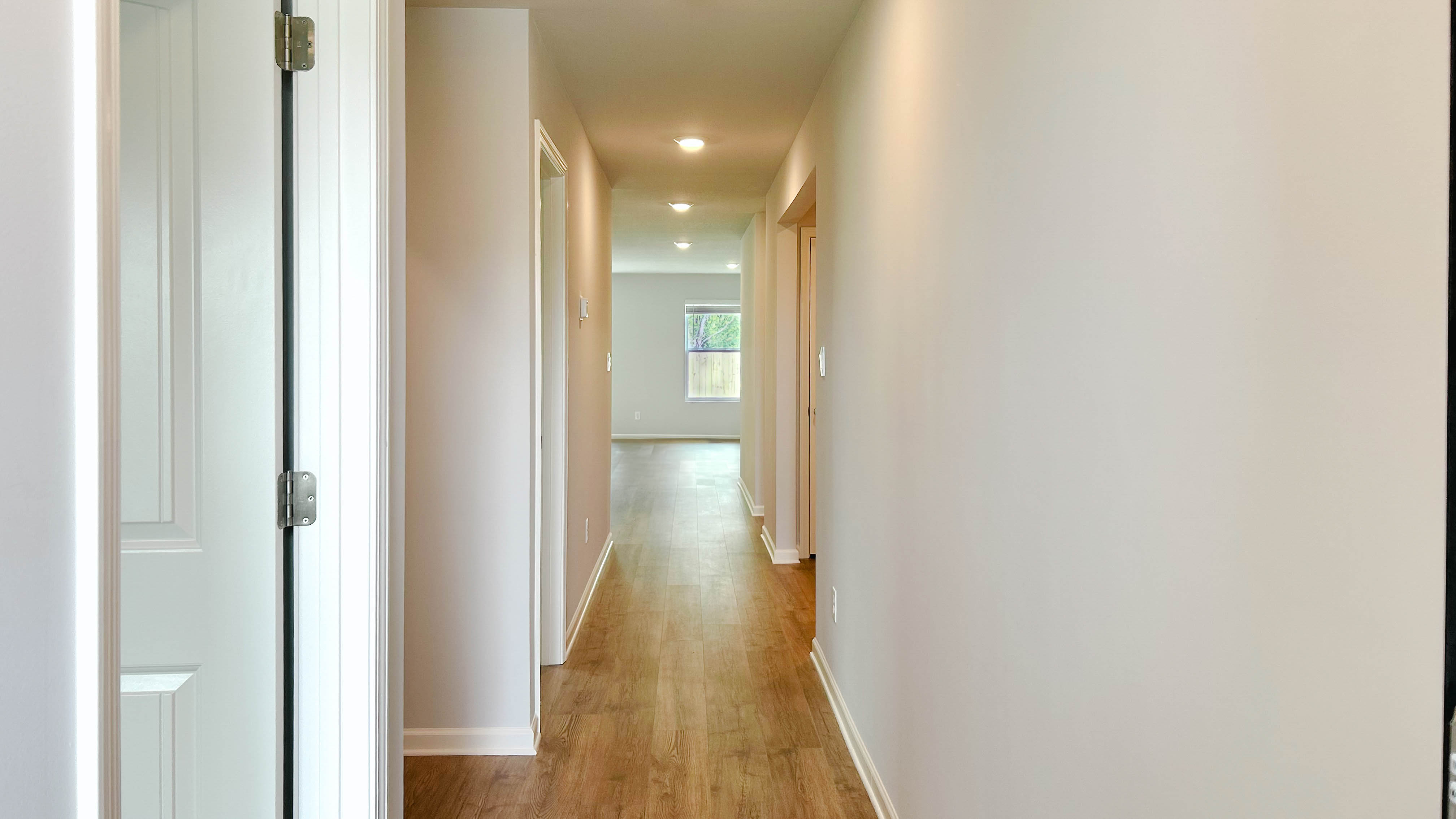 Front door entryway of the roland floorplan leading down the long entry hall
