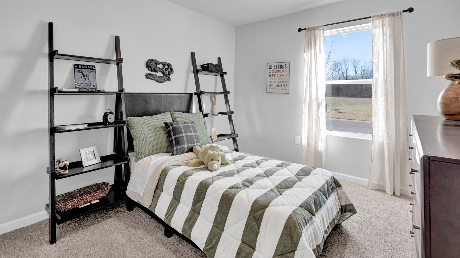 Bedroom three with a full size bed and a single window.