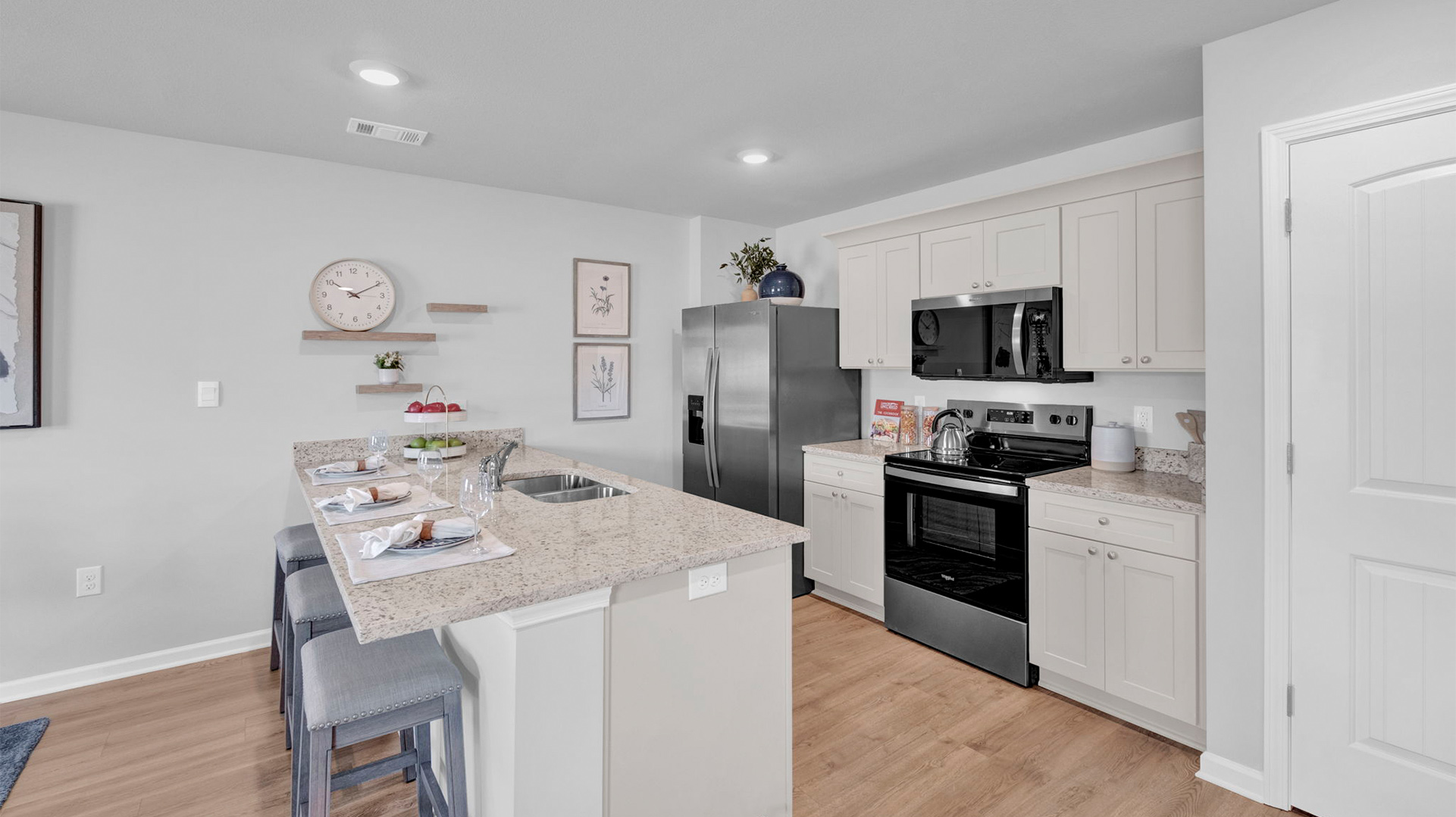 Beautiful kitchen with light cabinets and stainless steel appliances