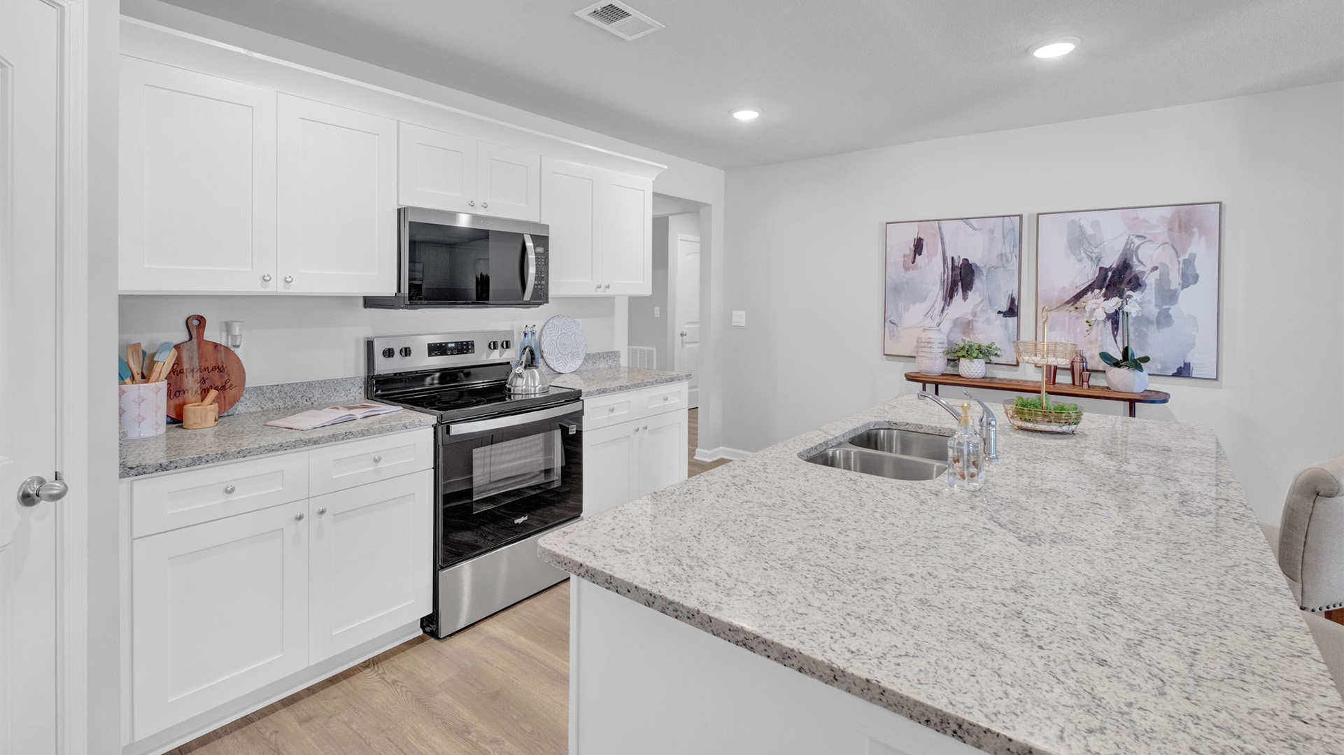 Kitchen opens up at the end of long entry hall
