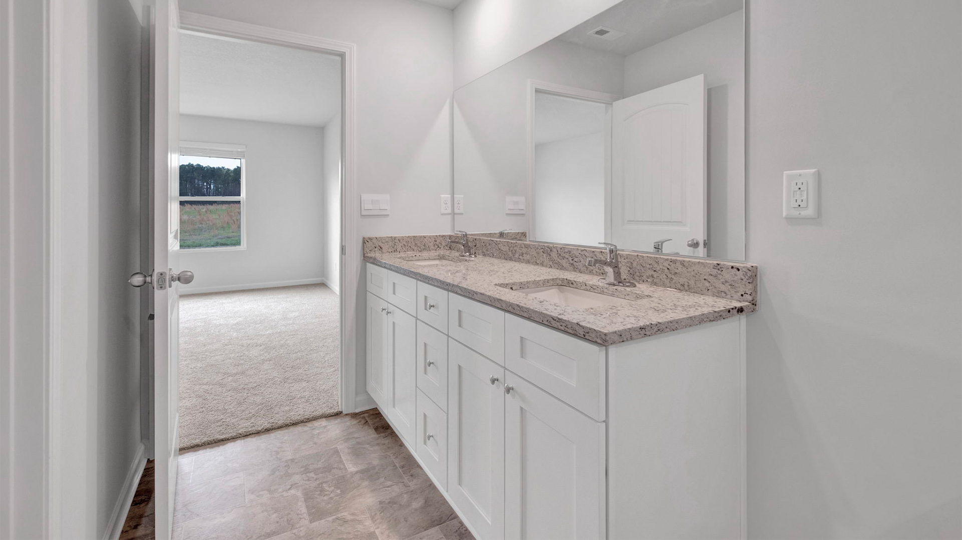EN suite primary bathroom with granite countertop vanity