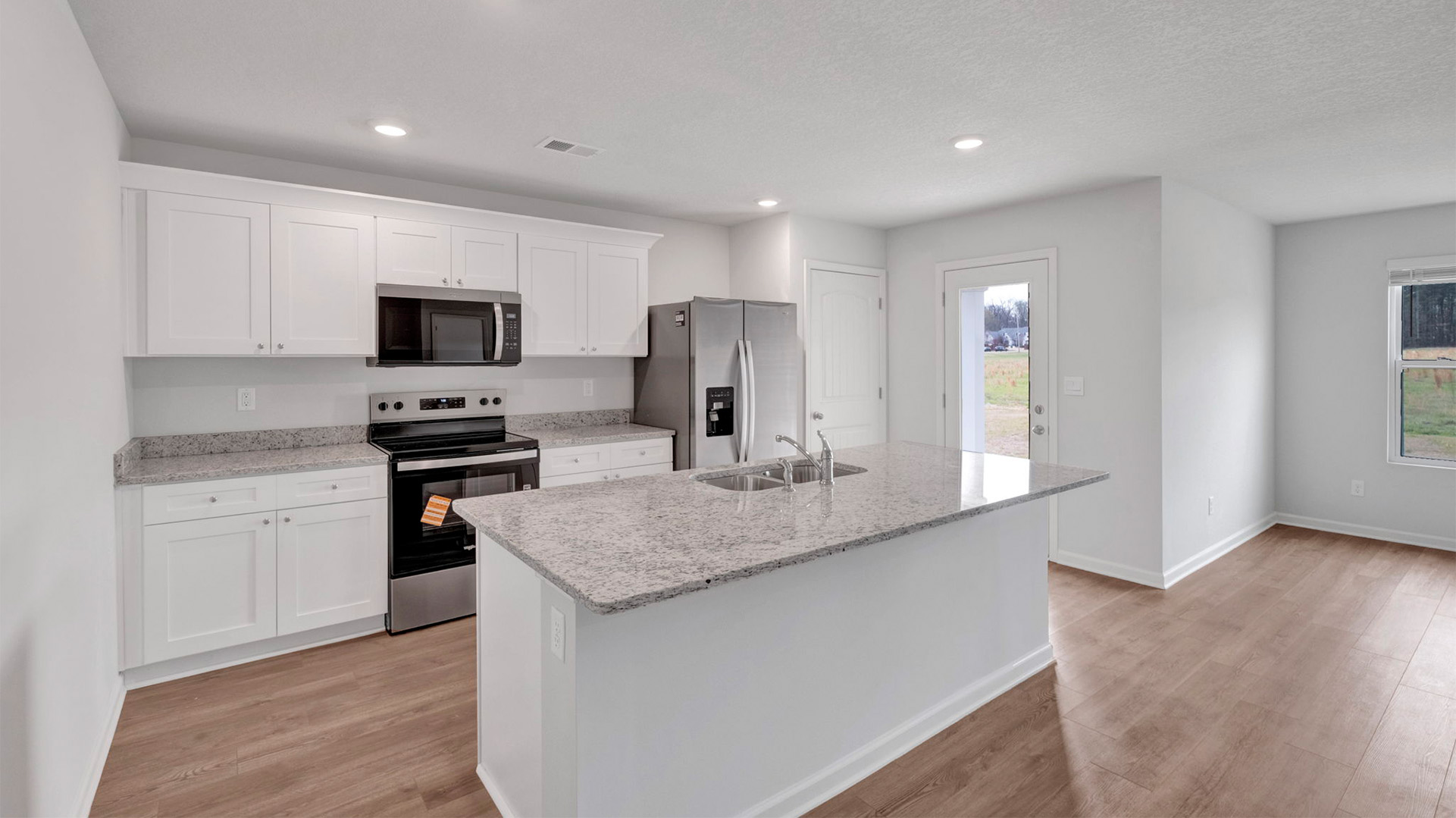 Beautiful kitchen area opens up at the end of long entry hall