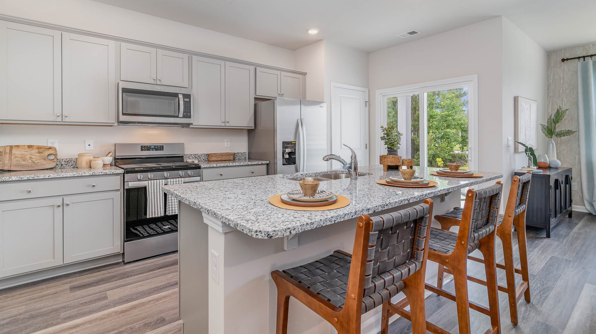 Kitchen area with light cabinets and stainless steel appliances