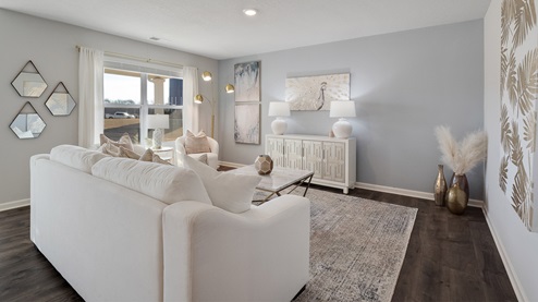 Living room area with neutral walls and vinyl flooring