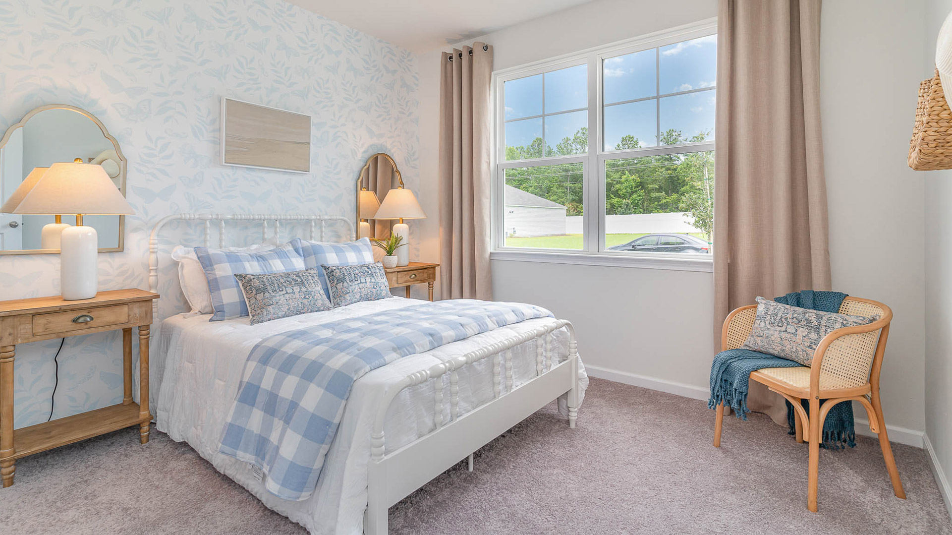 Second bedroom with a large double window overlooking the front yard