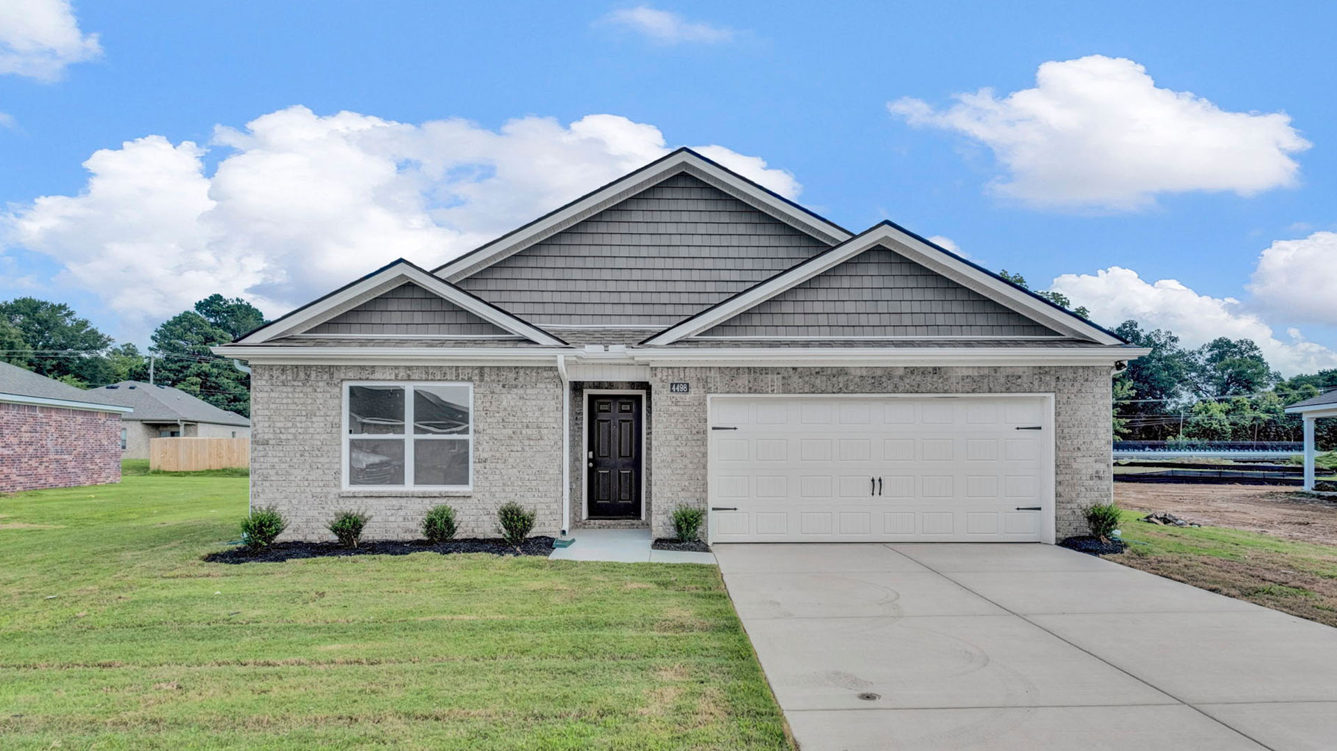 Exterior of the Cali F, a single story home with a two car garage