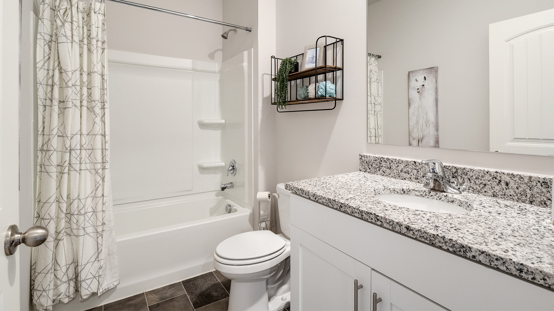 Second bathroom with a single vanity and an acrylic tub/shower insert
