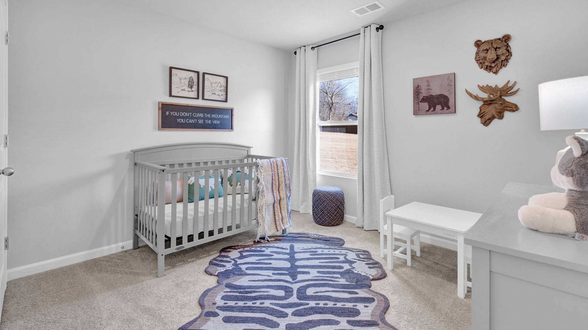 Third bedroom staged as a nursery