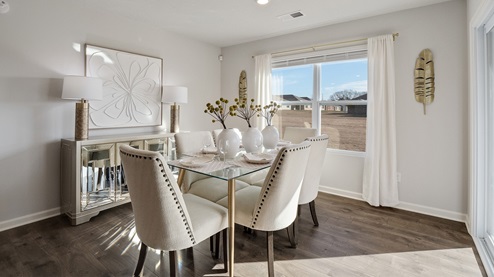 Dining area with a large double window overlooking the backyard