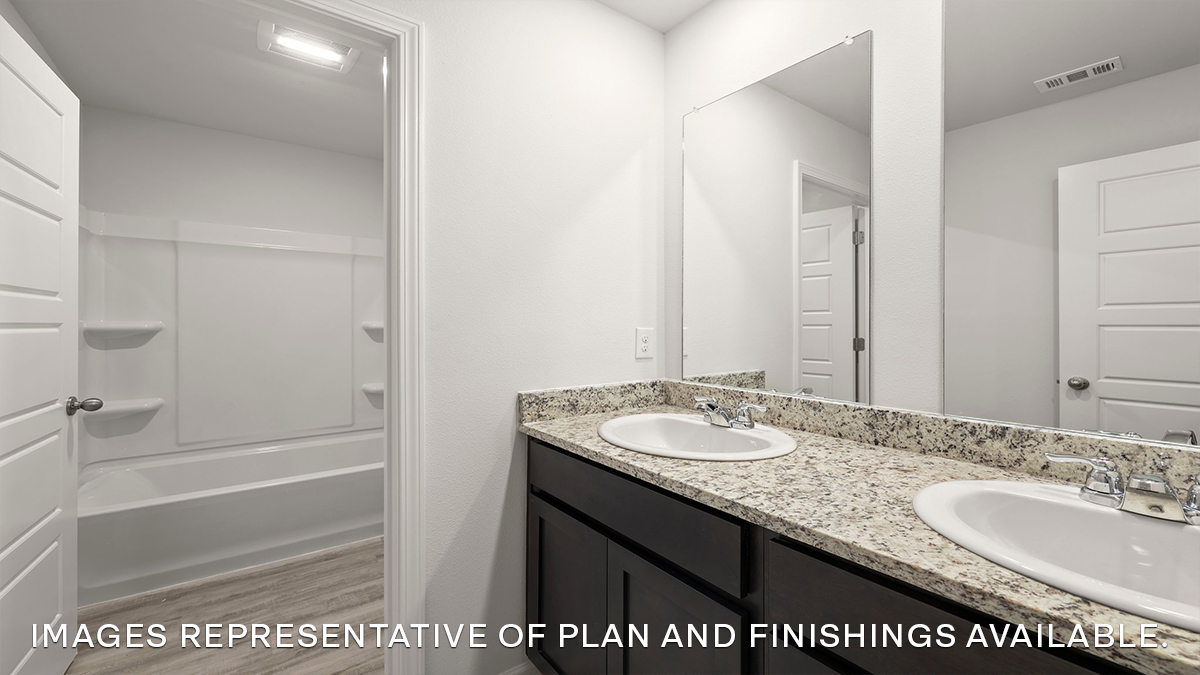 Second bathroom with a dual vanity and an acrylic tub/shower insert