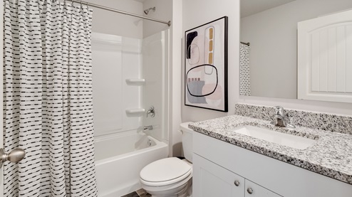Second bathroom with a single vanity and an acrylic tub/shower insert