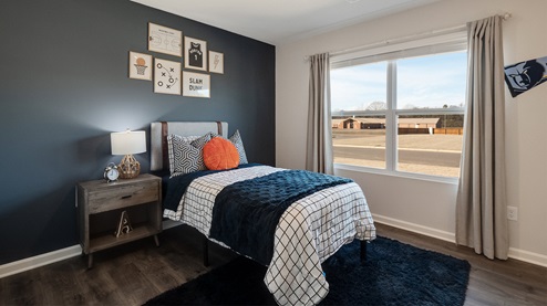 Third bedroom with a large double window overlooking the front yard