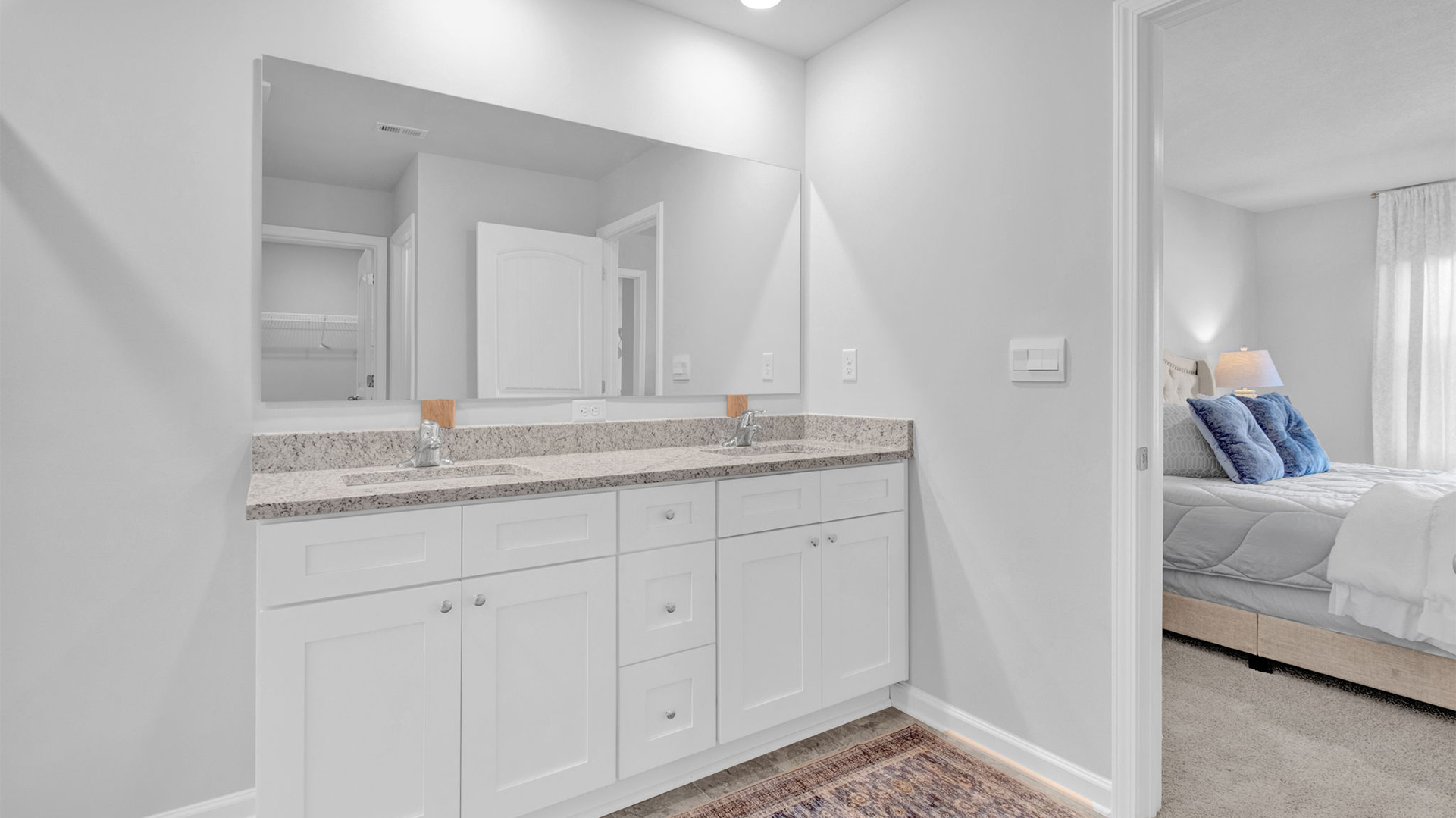 Primary bathroom opens up with a double vanity with two sinks