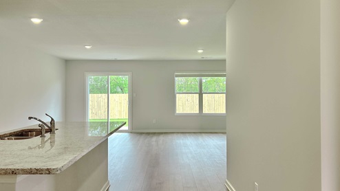 End of long entry hall leading into the kitchen area