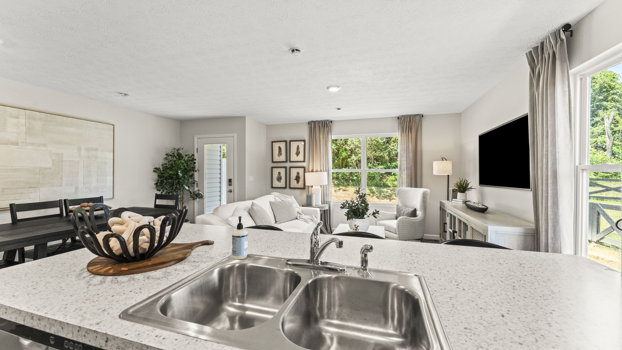 Quartz countertop kitchen island overlooking the dining and living room