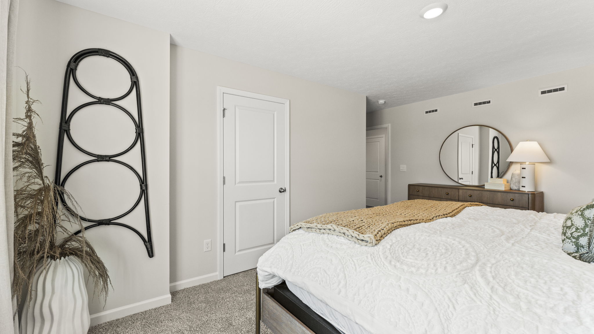 Primary bedroom comfortably fits a king size bed and additional bedroom furniture