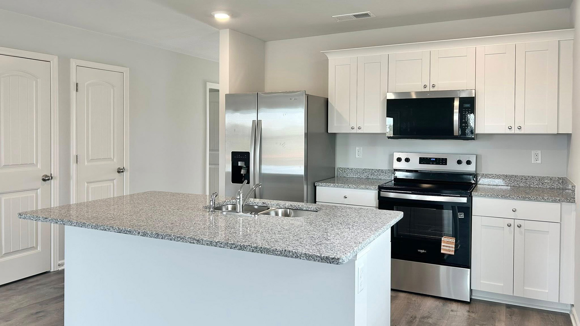 Beautiful kitchen opens up at the end of entry hall