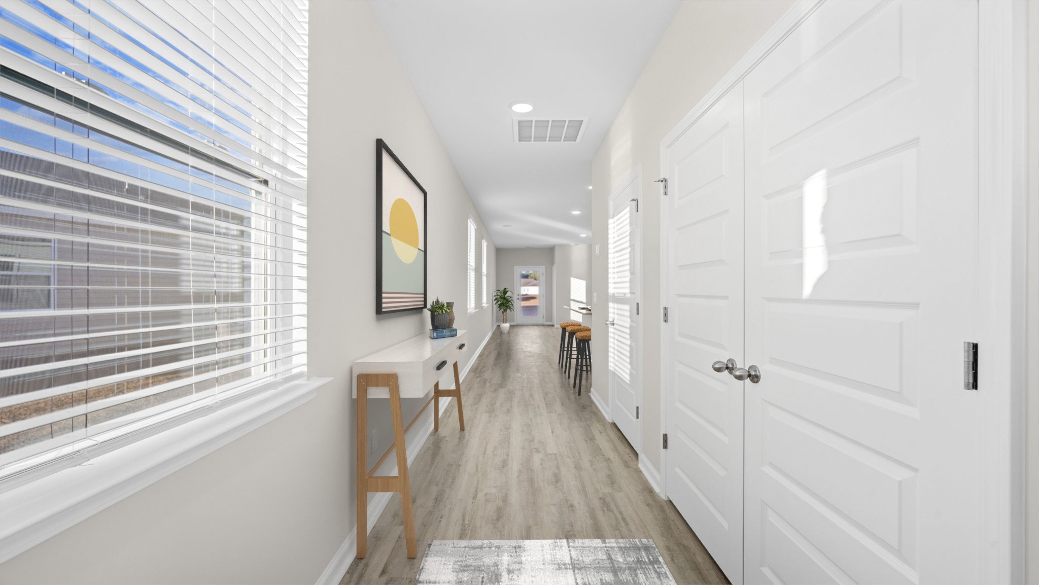 Front door entryway leading down the long entry hall