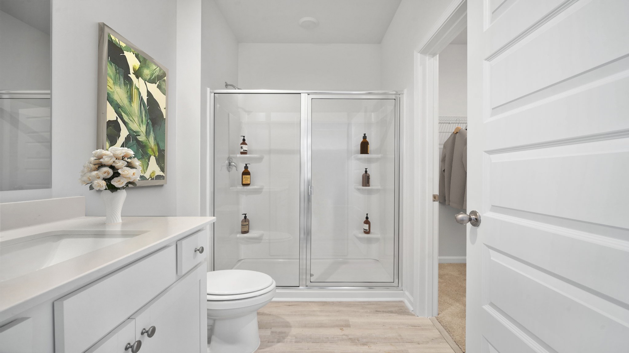 En suite primary bathroom with a walk in shower