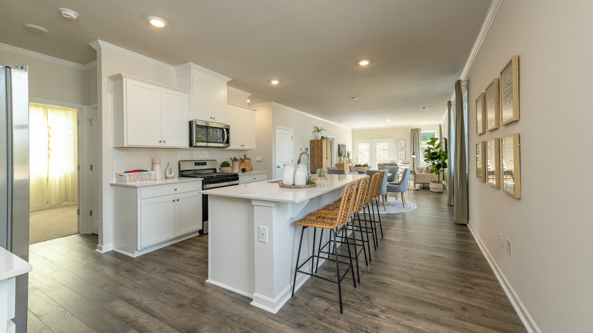 End of long entry hall opening up into the spacious kitchen area