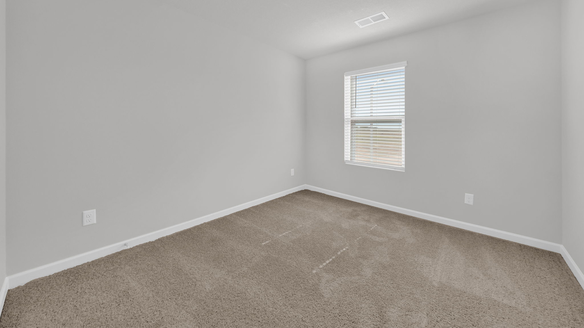 Second bedroom with carpet flooring