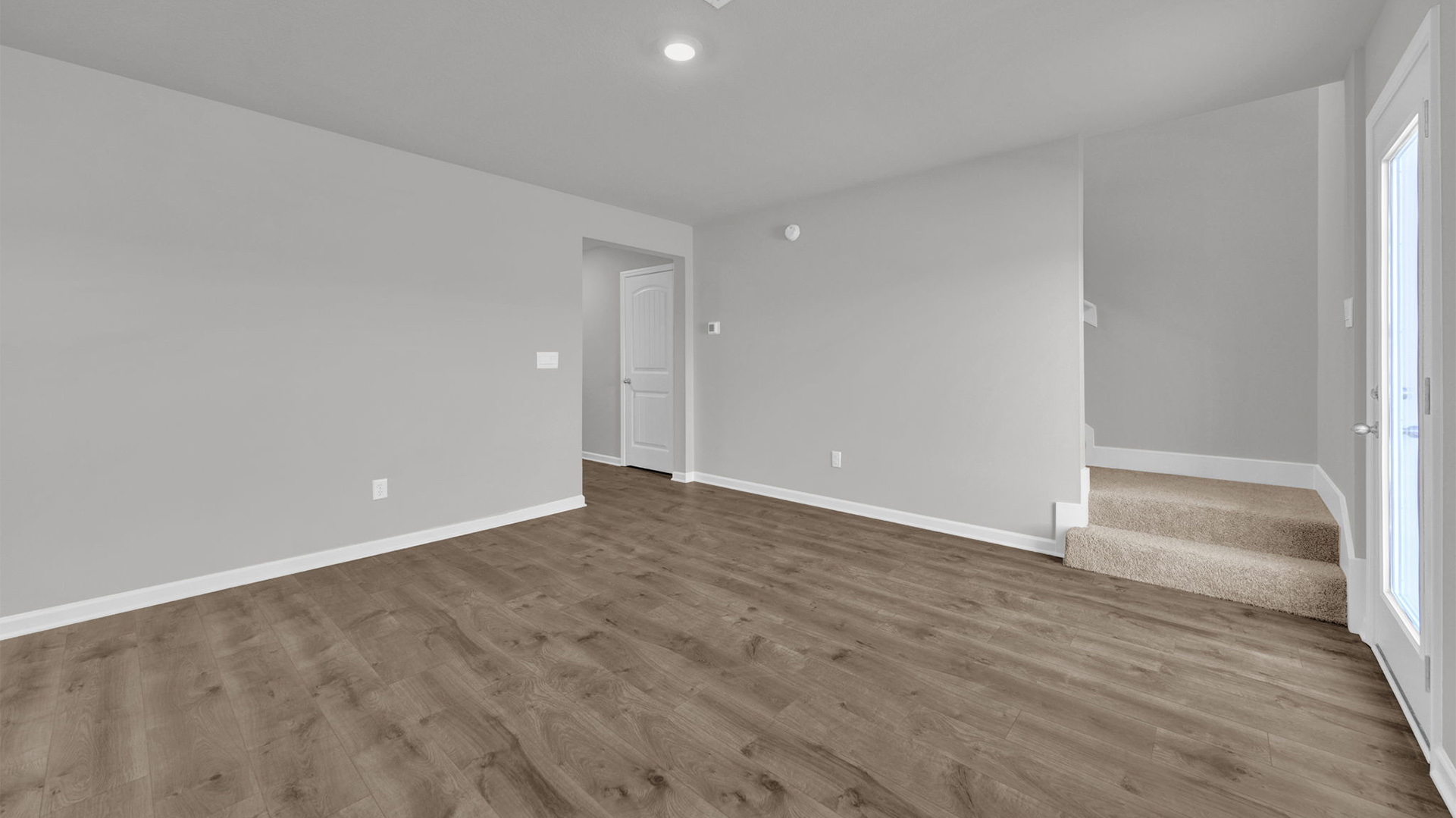 Living room with back wall leading into the stairway