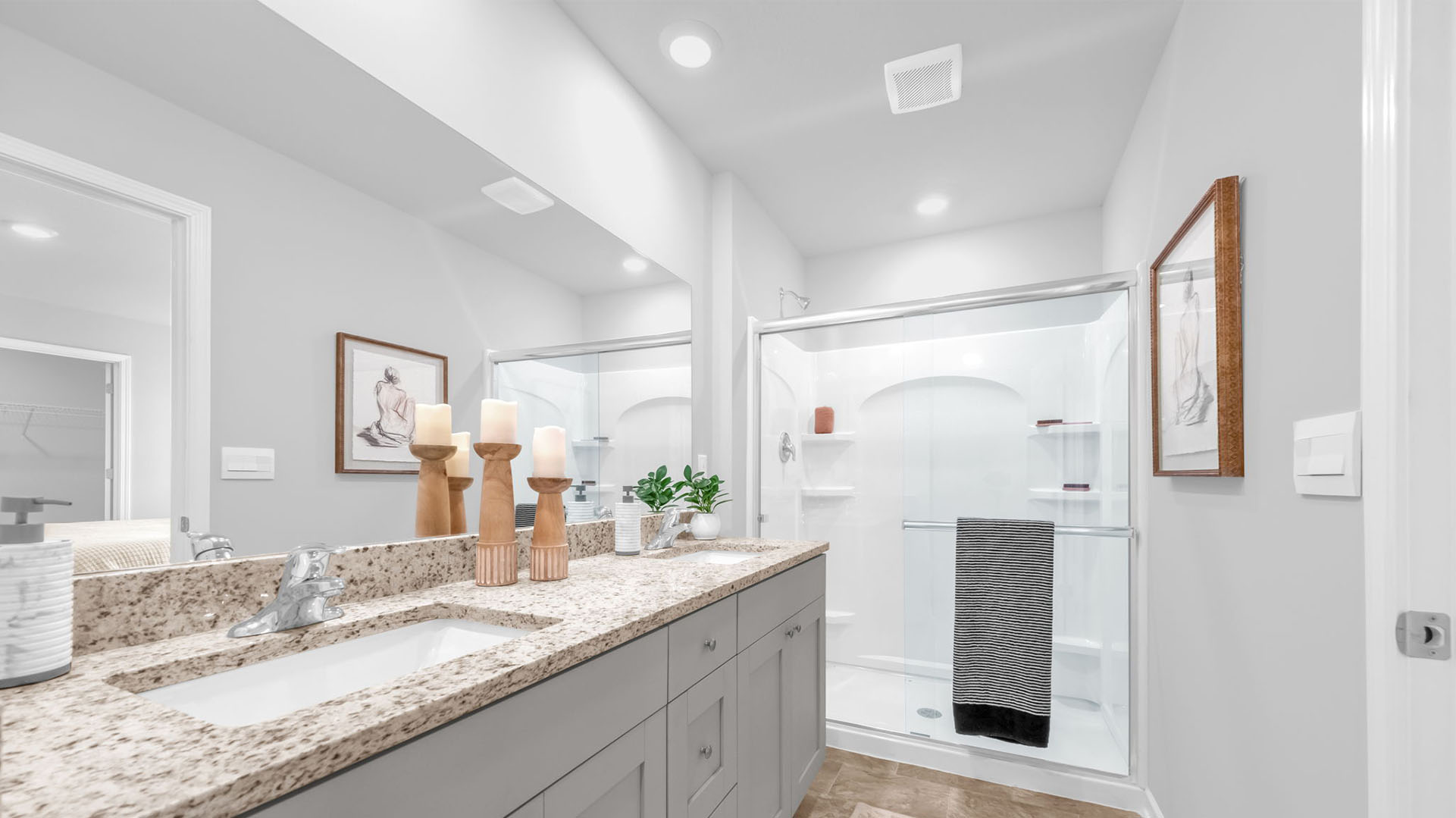 En suite primary bathroom with granite countertops