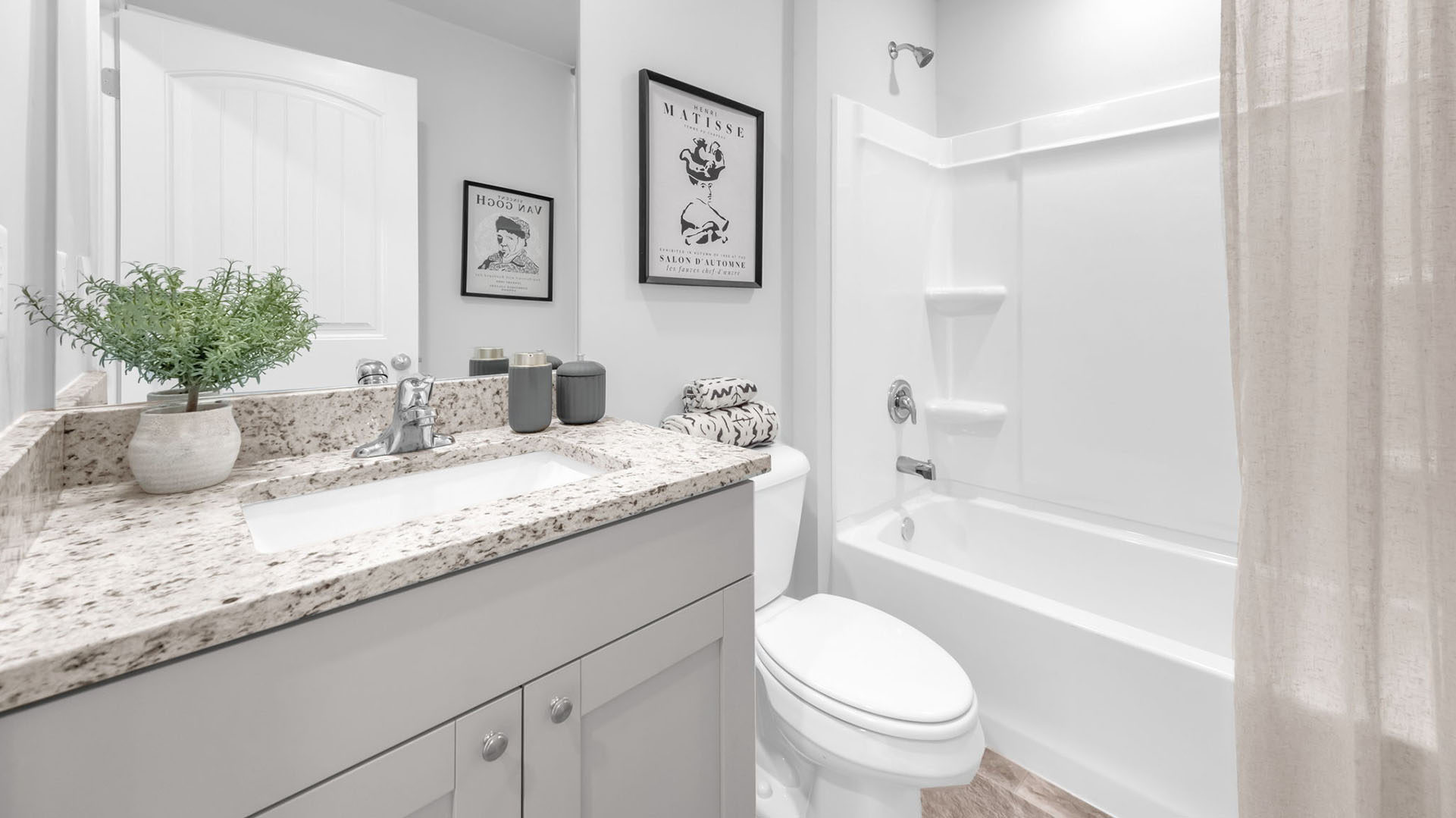 Second bathroom with a single vanity and acrylic tub/shower insert