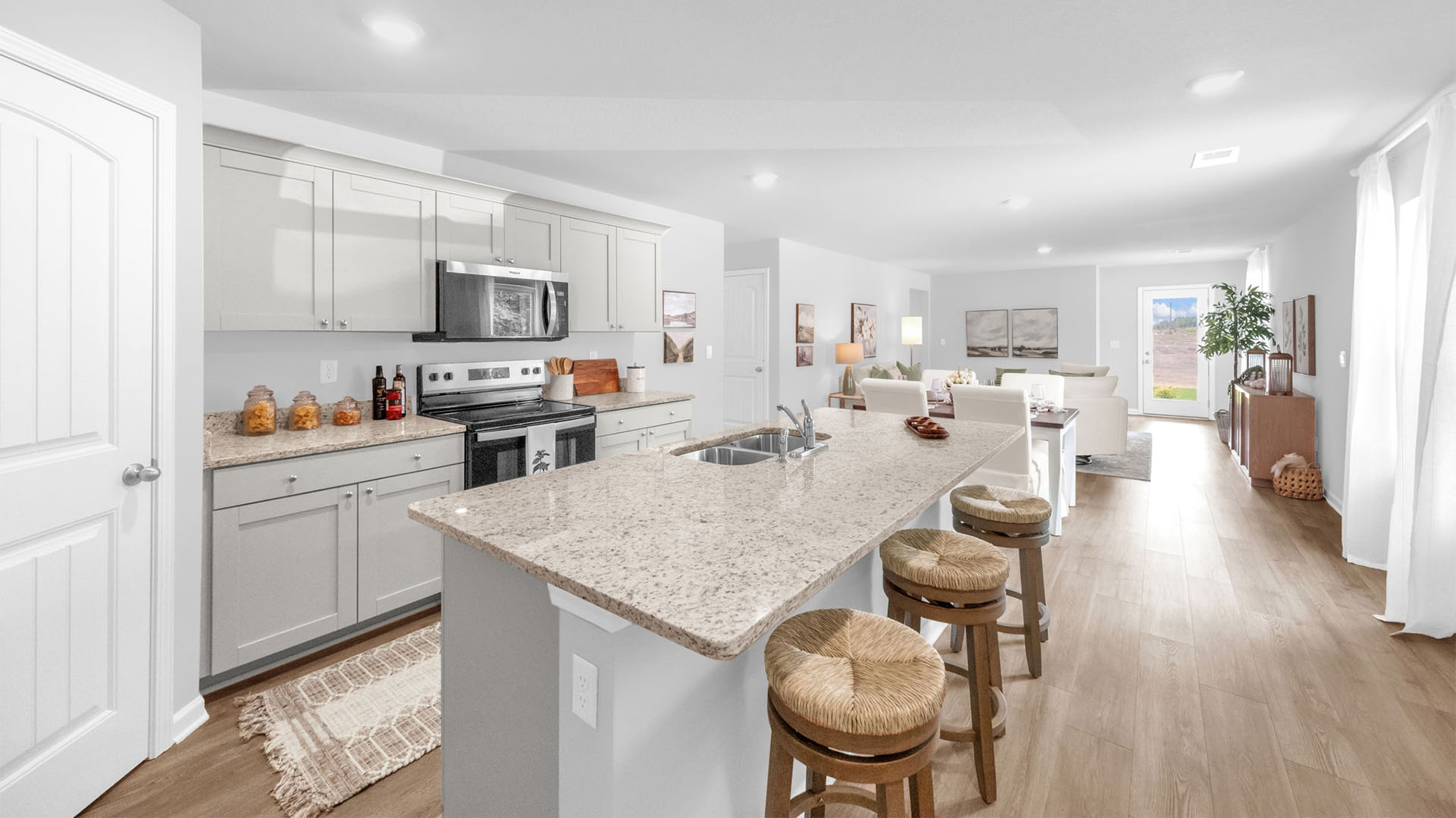 Kitchen area opens up at the end of long entry hall