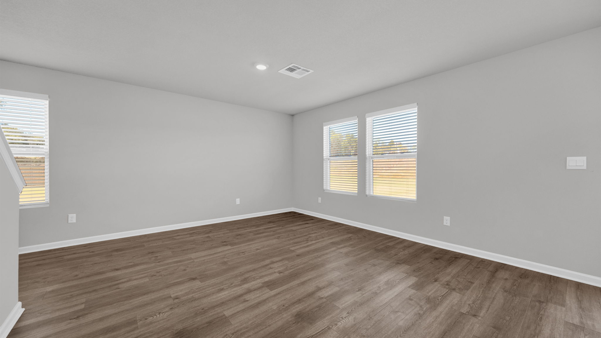 Living room with a large double window overlooking the backyard
