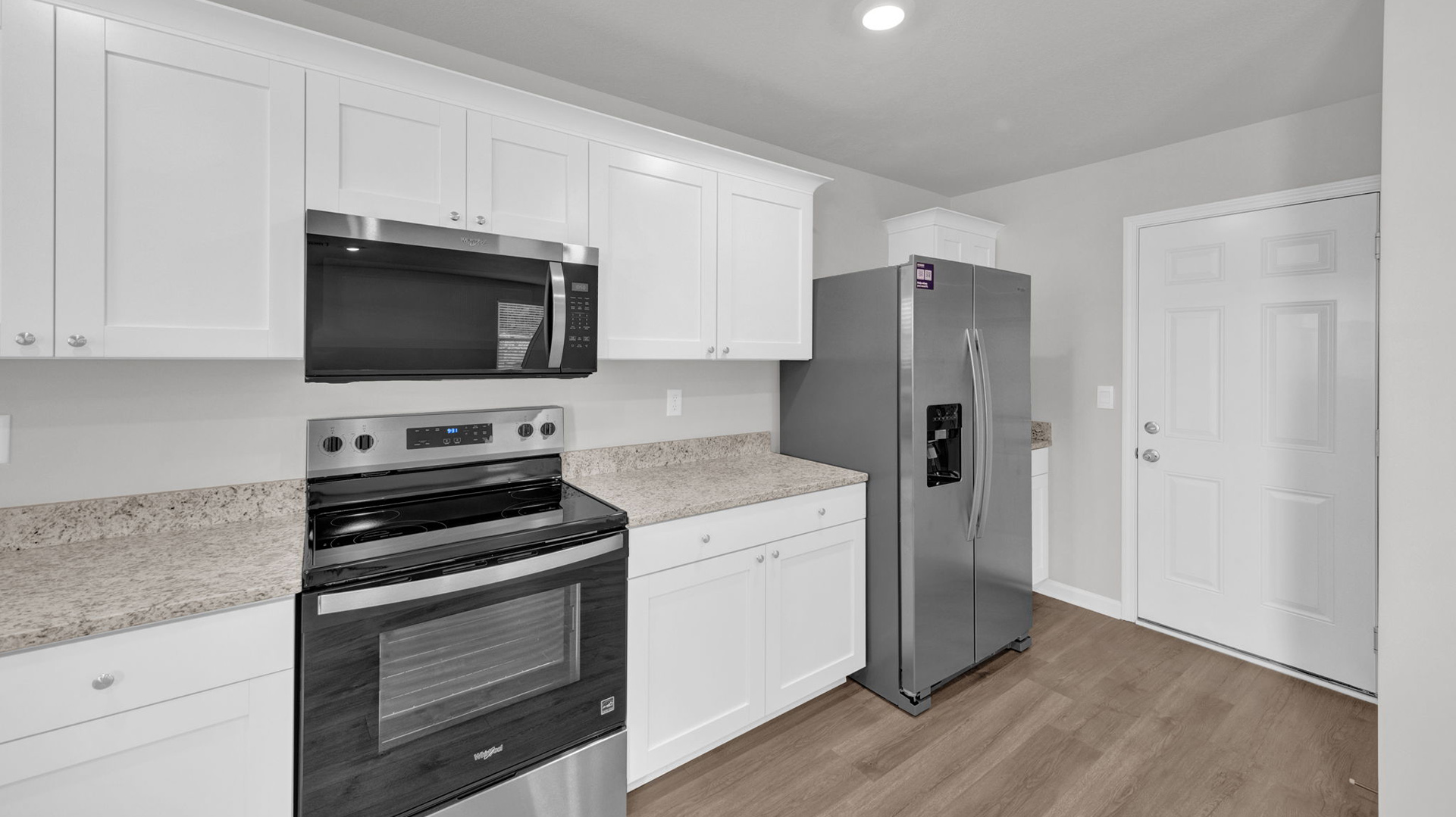 Kitchen area opens up entering into the home through the garage door
